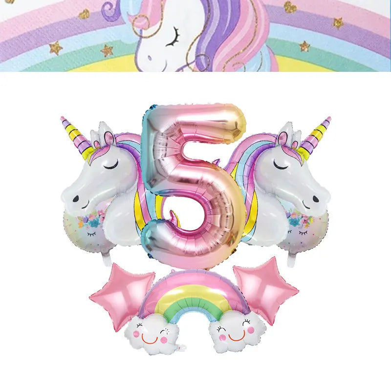 A pink foil number five balloon shaped like a unicorn and a rainbow arch decoration for a girl's birthday party
