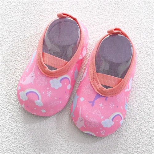 Pink baby barefoot water shoes with a floral pattern and pink lining