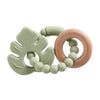 A light green silicone planet teether with a wooden ring and a beaded chain for babies.