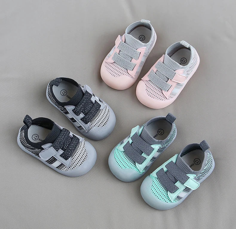 A collection of pink and gray breathable mesh toddler walking shoes for infants