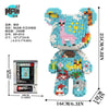 A colorful brick art bear figure made of building blocks with a packaging box visible.