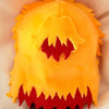 A cute anime plush doll resembling a demon with orange and red features.