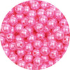 A close-up view of pink imitation pearl beads used for DIY jewelry making.