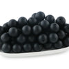 A pile of small, round black silicone beads for jewelry making and DIY crafts.