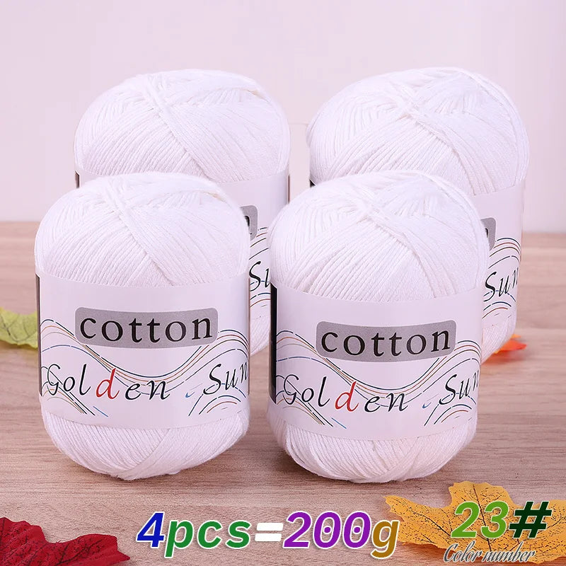 Four balls of white cotton knitting yarn for crochet and handmade projects