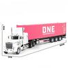 A white diecast container truck model on a flat surface with a pink shipping container in the background.