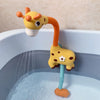 A yellow duck bath toy set with an orange sliding track pouring water into a blue bathtub.