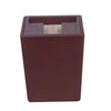 A dark brown wooden box with a square opening revealing a light-colored puzzle piece inside.