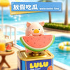 Lulu the Piggy light-sensing movable figurine in a watermelon slice design sitting on a decorative box.