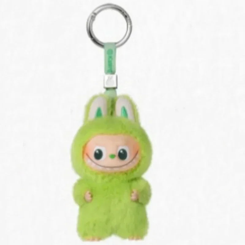 A small, green Labubu plush doll attached to a metal keyring.