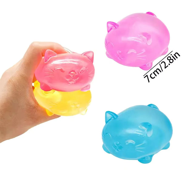 A hand holds a pink plastic cat toy, next to a yellow and blue plastic cat toy.