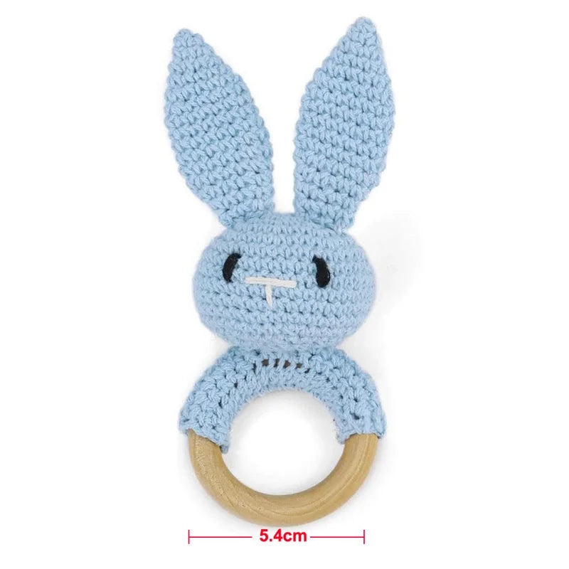 A light blue wooden baby rattle and teether ring shaped like a bunny.