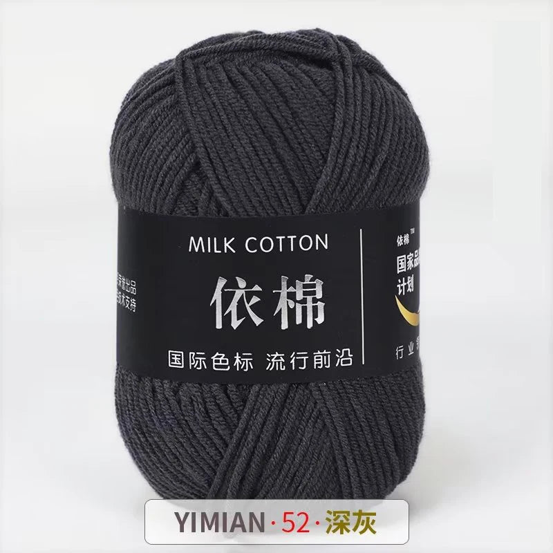 A skein of dark gray milk cotton yarn labeled with Chinese characters and a size indicator.