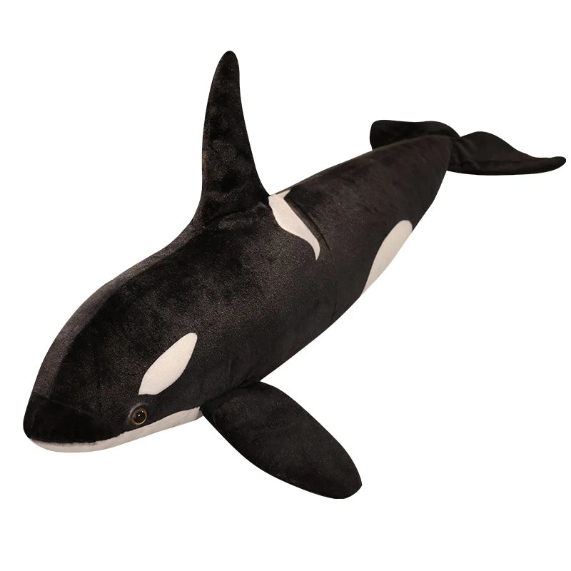 A black and white lifelike orca whale plush toy with a fin.