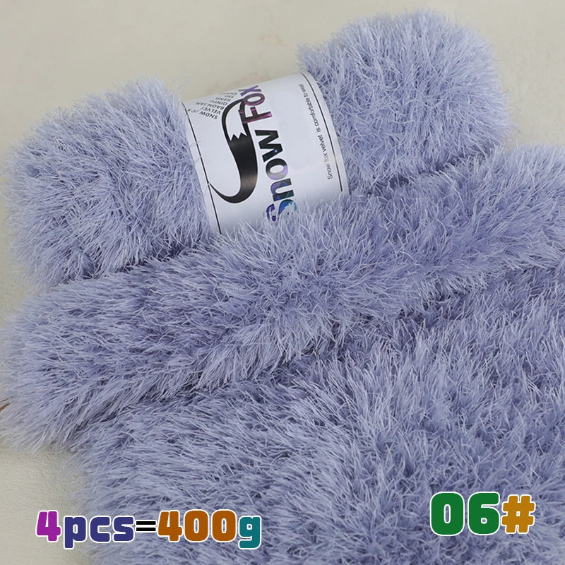 A close-up of a light purple chunky faux fur yarn skein with the brand name SnowFox visible.