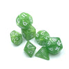 A collection of seven small green polyhedral dice showing various numbers and shapes.