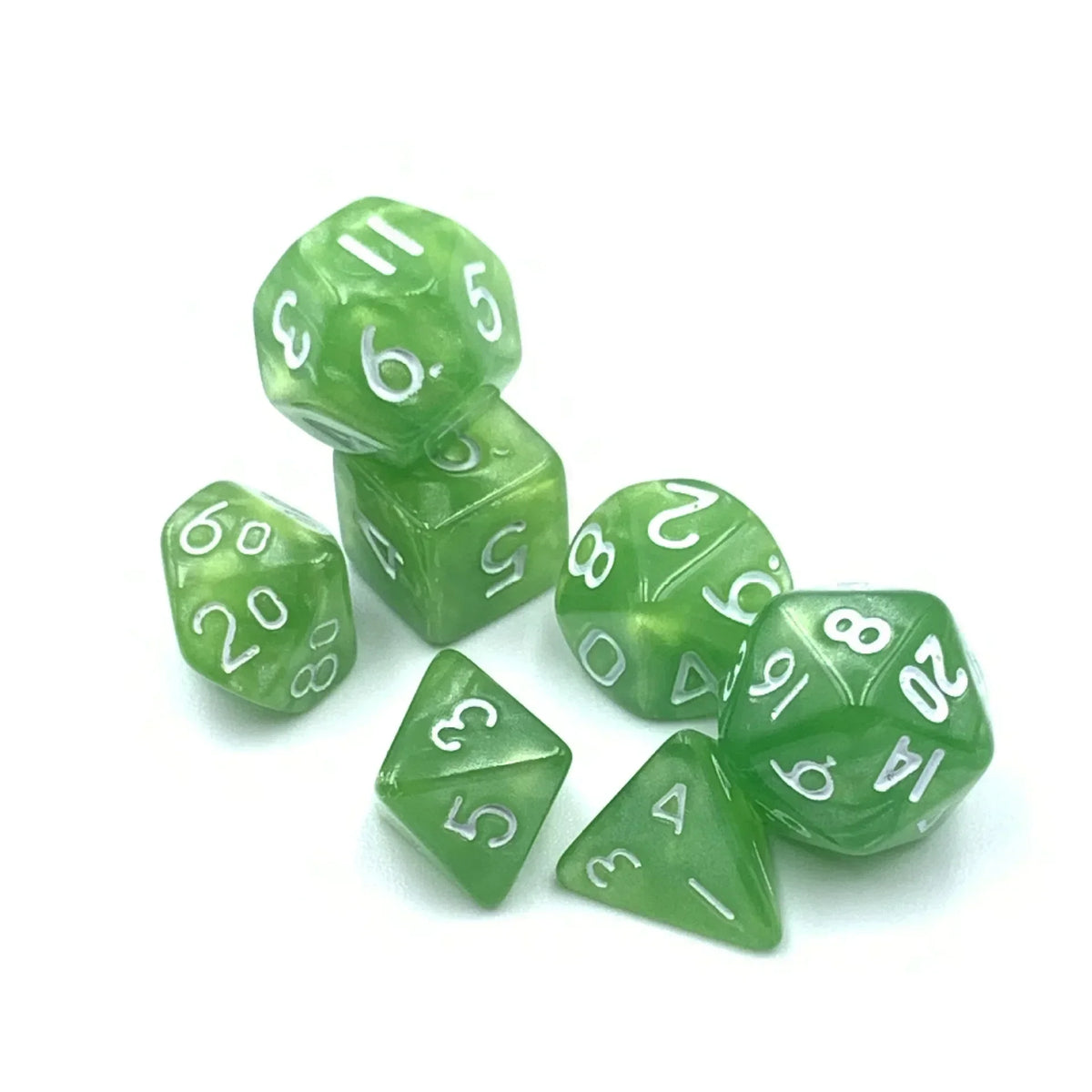 A collection of seven small green polyhedral dice showing various numbers and shapes.
