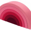 A rainbow-shaped silicone toy with concentric pink and magenta layers.