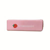 A pink butter squishy stress relief toy shaped like a strawberry with the word STRAWBERRY printed on it.