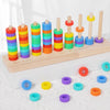 A wooden ring toss game with colorful rings stacked on dowels, showing various colors like red, orange, yellow, green, cyan, 