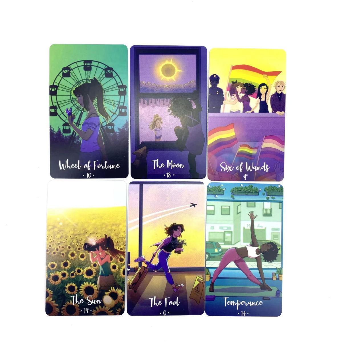 A collection of ten Cosmic Cycles Oracle cards featuring celestial and nature themes like Wheel of Fortune, The Moon, and Six