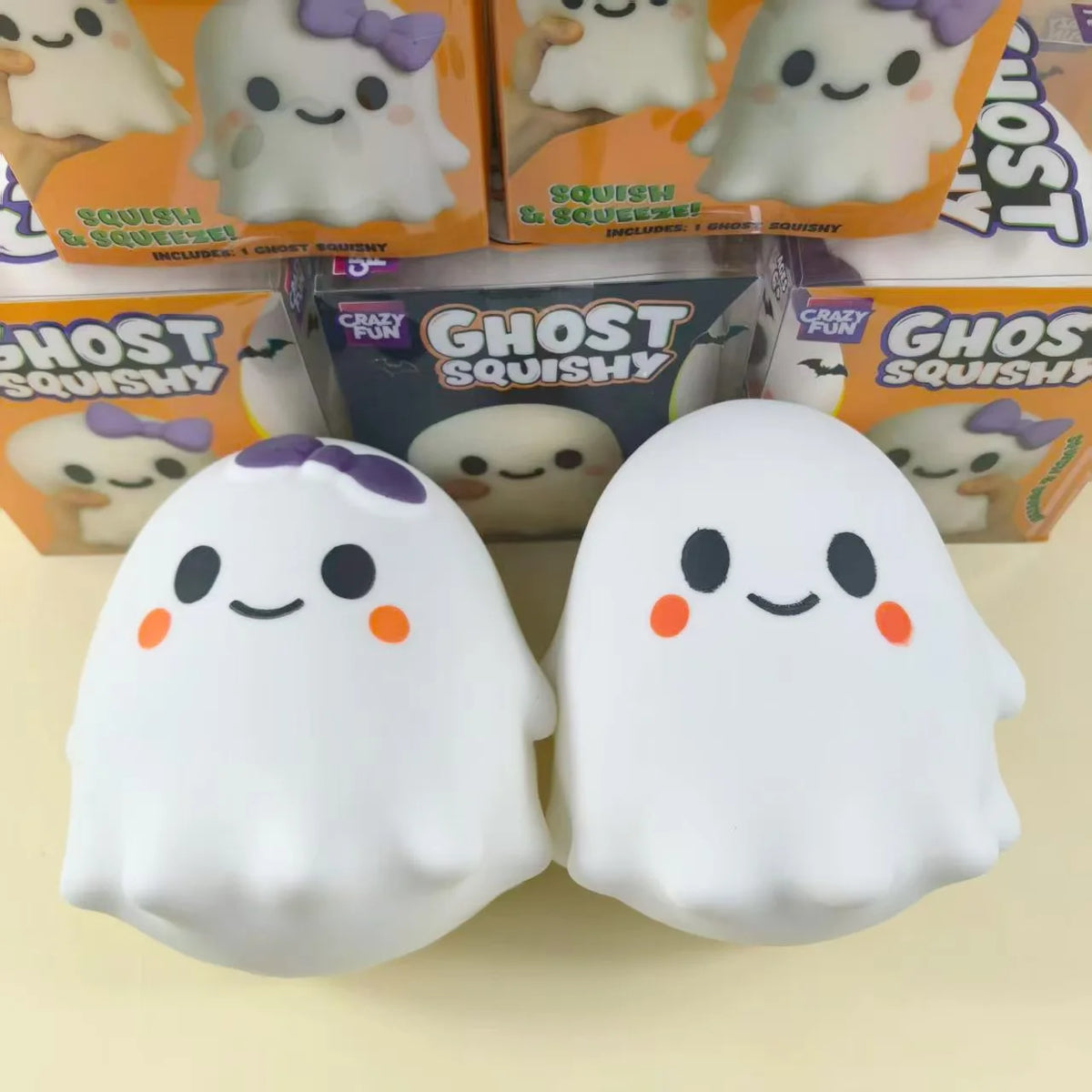 Two white ghost squishy toys with purple accents are shown against a light background.