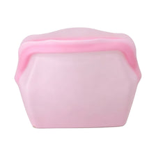 A pink reusable silicone storage bag with a slightly domed shape.