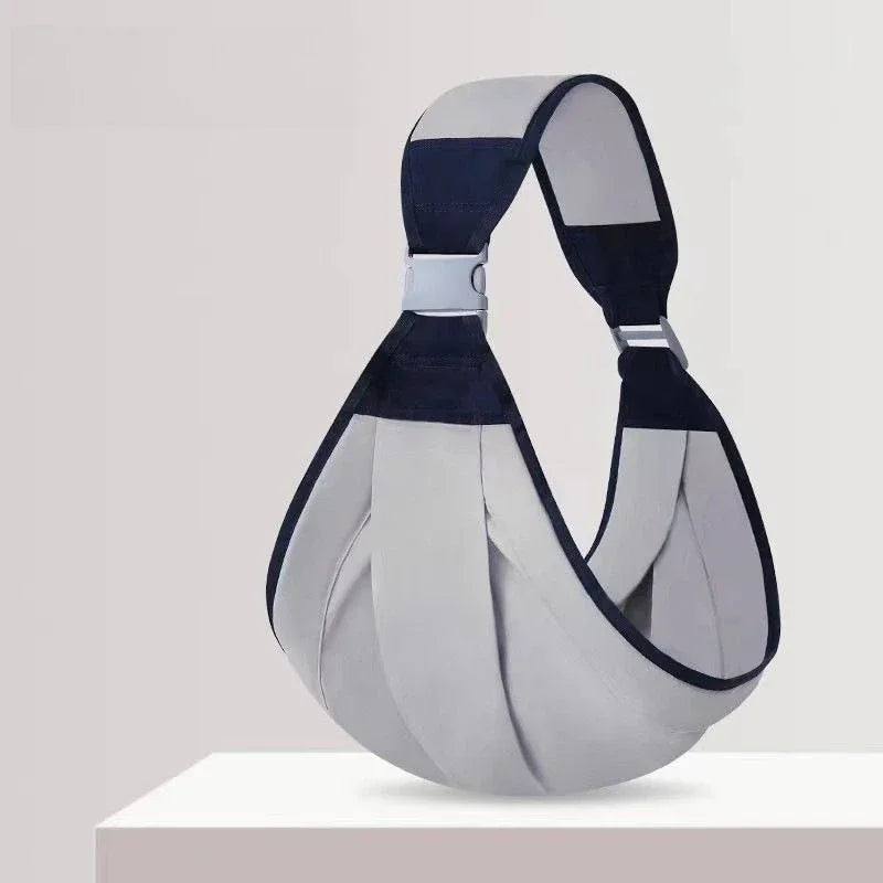 A gray and navy adjustable cotton ring sling baby carrier displayed on a white surface.