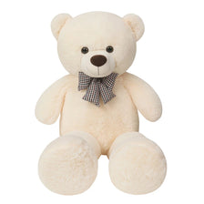A large, cream-colored teddy bear plush toy with a brown nose and a checkered bow tie.
