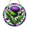 Round acrylic window hanging featuring a purple thistle flower design with green leaves and purple accents.