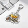 An acrylic keychain charm featuring a stylized armored character in gold and silver tones.