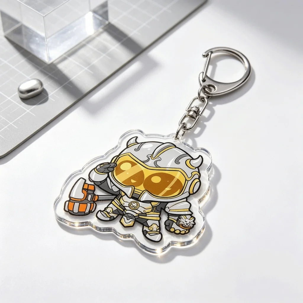 An acrylic keychain charm featuring a stylized armored character in gold and silver tones.