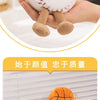 A white plush doll resembling a baseball, shown next to a display of various sports-themed plush toys.