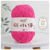 A ball of bright pink chenille yarn labeled for knitting and crochet