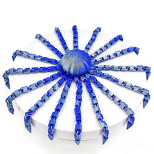 A blue octopus desktop statue with eight tentacles radiating from a central sphere.