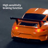 Orange mini RC drift car with a black spoiler and red taillights