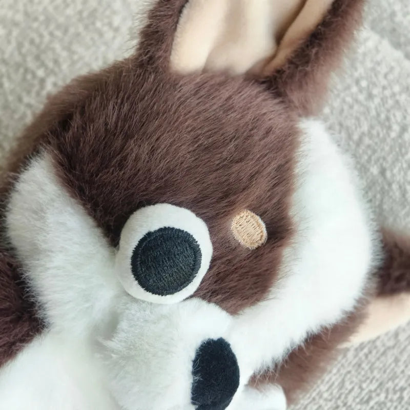 A brown and white chihuahua plush doll with its tongue sticking out