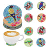 A set of DIY diamond art coasters featuring various bird designs on colorful tiles.