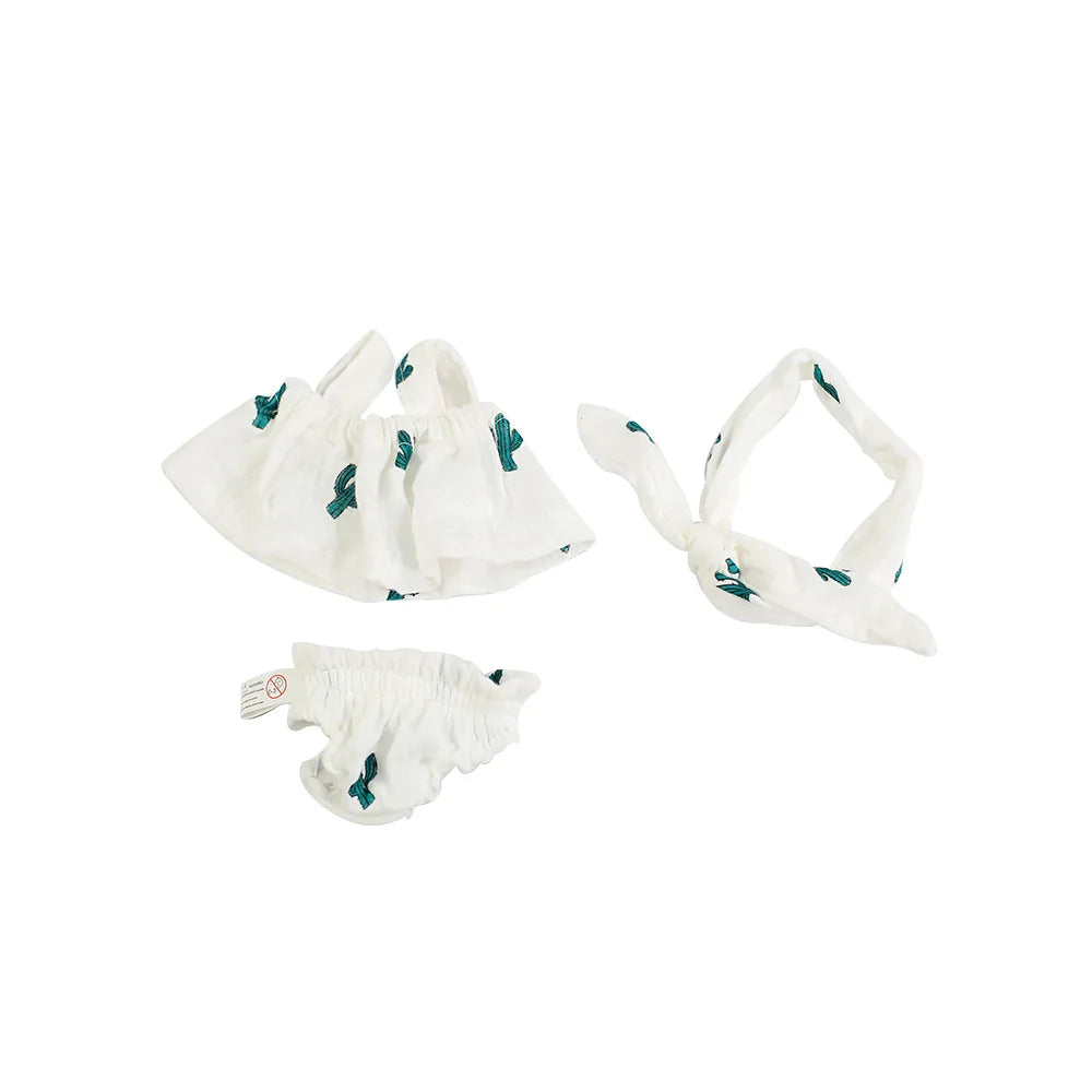 A set of three white doll outfits featuring green cactus designs for baby dolls.