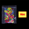 A clear plastic bag filled with 100 glow-in-the-dark loom band bracelets in various bright colors.