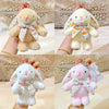 A soft pink bunny plush keychain with a floral bow charm is shown in multiple angles.
