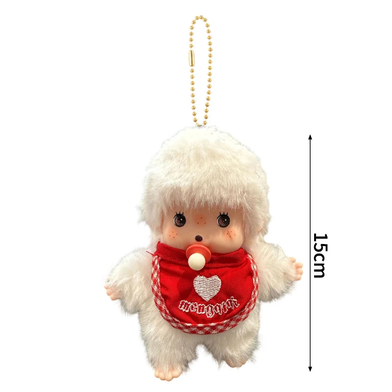 A white fluffy cartoon plush character with pink skin and a red heart-shaped fabric detail, hanging from a gold chain.