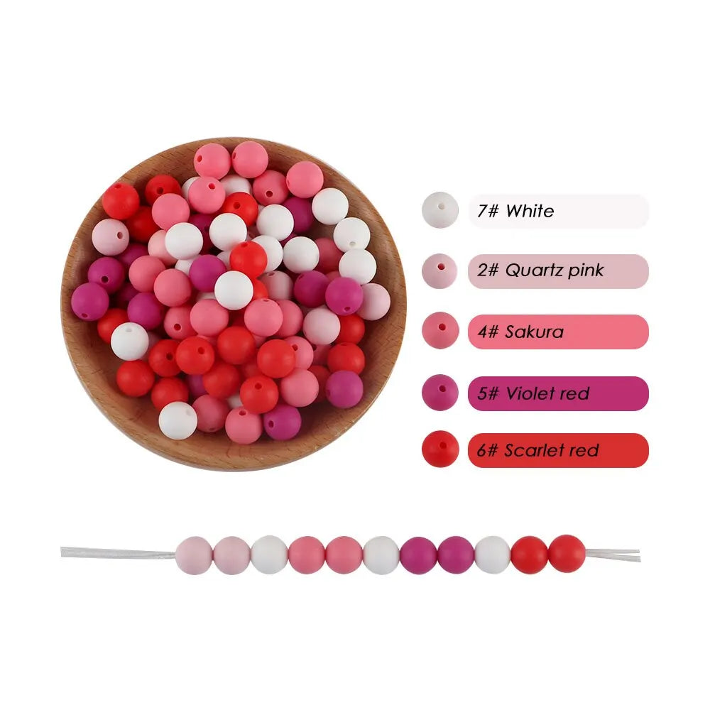 A collection of silicone round beads in various shades of pink and white, including quartz pink, sakura, violet red, and scar
