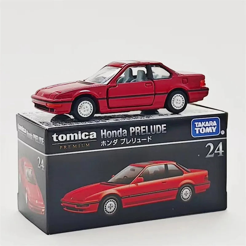 A red Tomica Honda Prelude die-cast model car displayed in its packaging box.