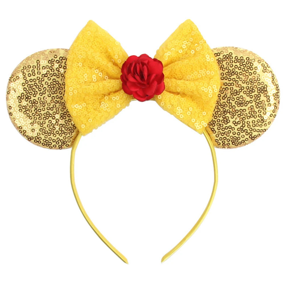 A yellow bow headband accessory set featuring a red rose and gold sequin accents.