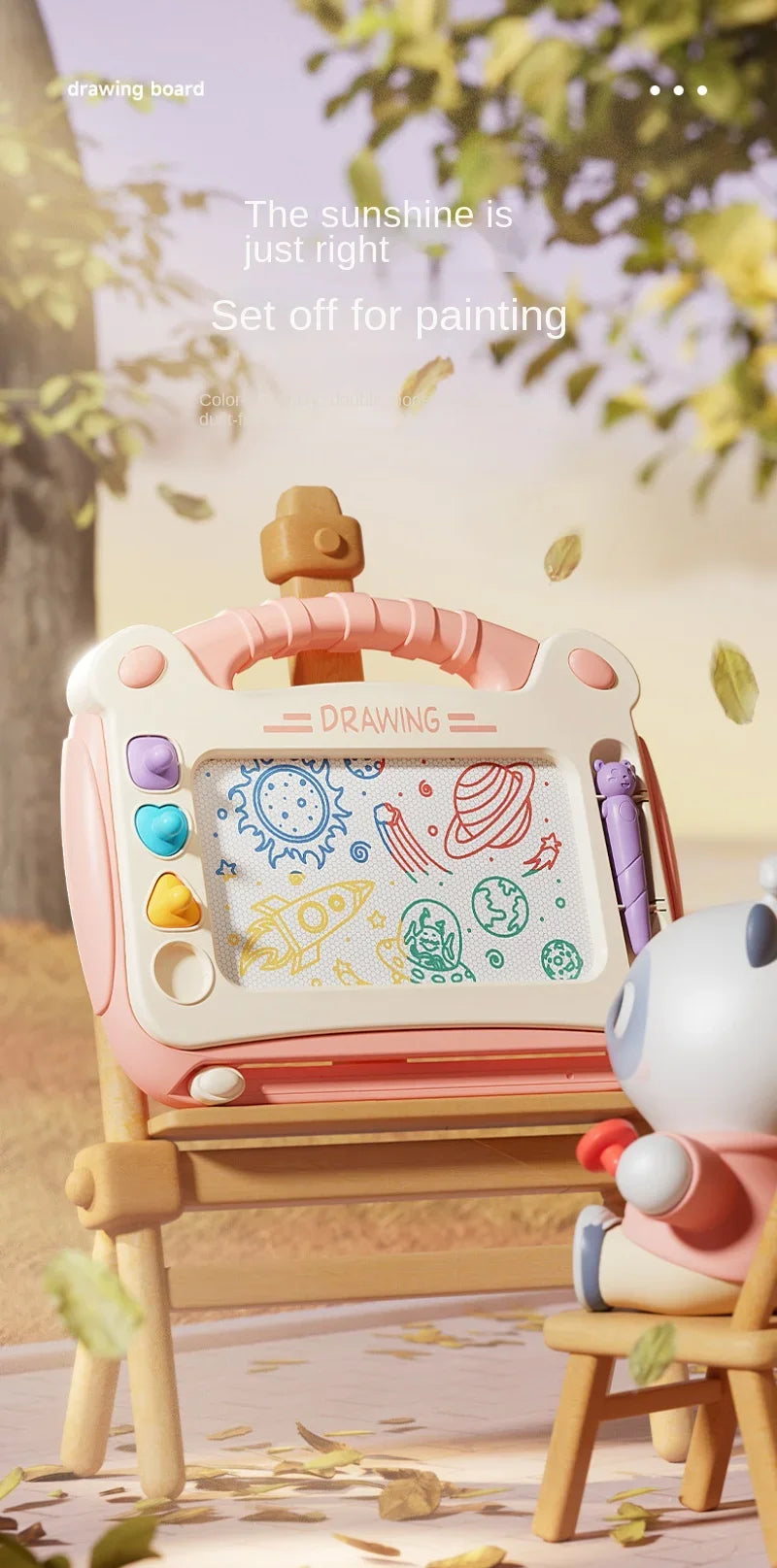 A pink magnetic drawing board for kids is shown on a wooden table with scattered leaves.