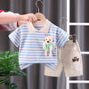 A baby outfit set featuring a striped blue and white t-shirt and matching beige shorts hanging on a wooden hanger.