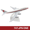 Diecast model of a Japanese airliner in white and red livery.