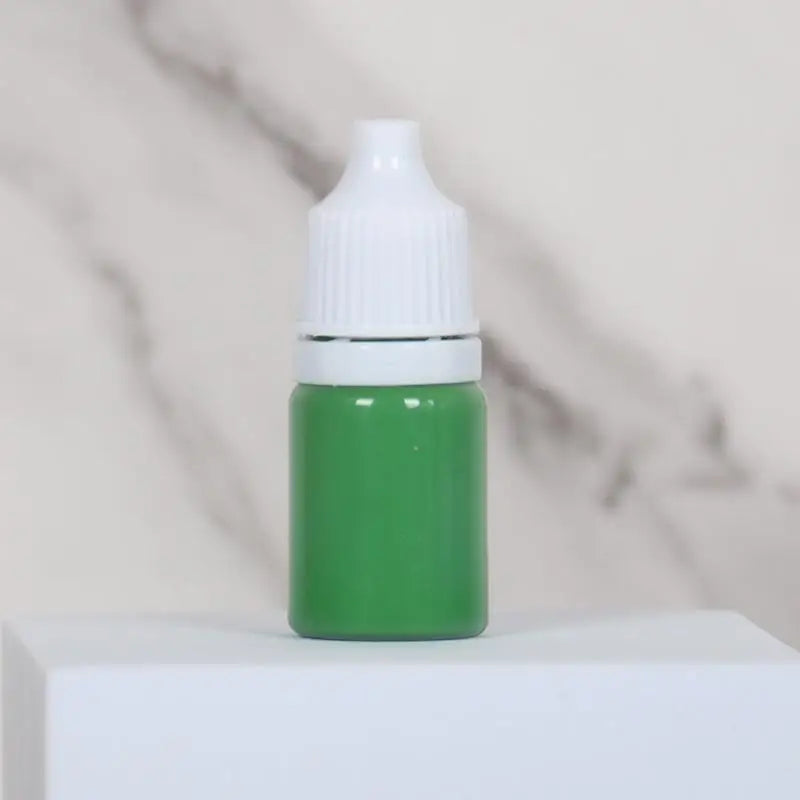A small green bottle of water marbling paint art kit for kids with a white cap