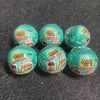 Five green Mini Verse vending machine toys with snack dispensers and surprise balls arranged on a dark gray surface.